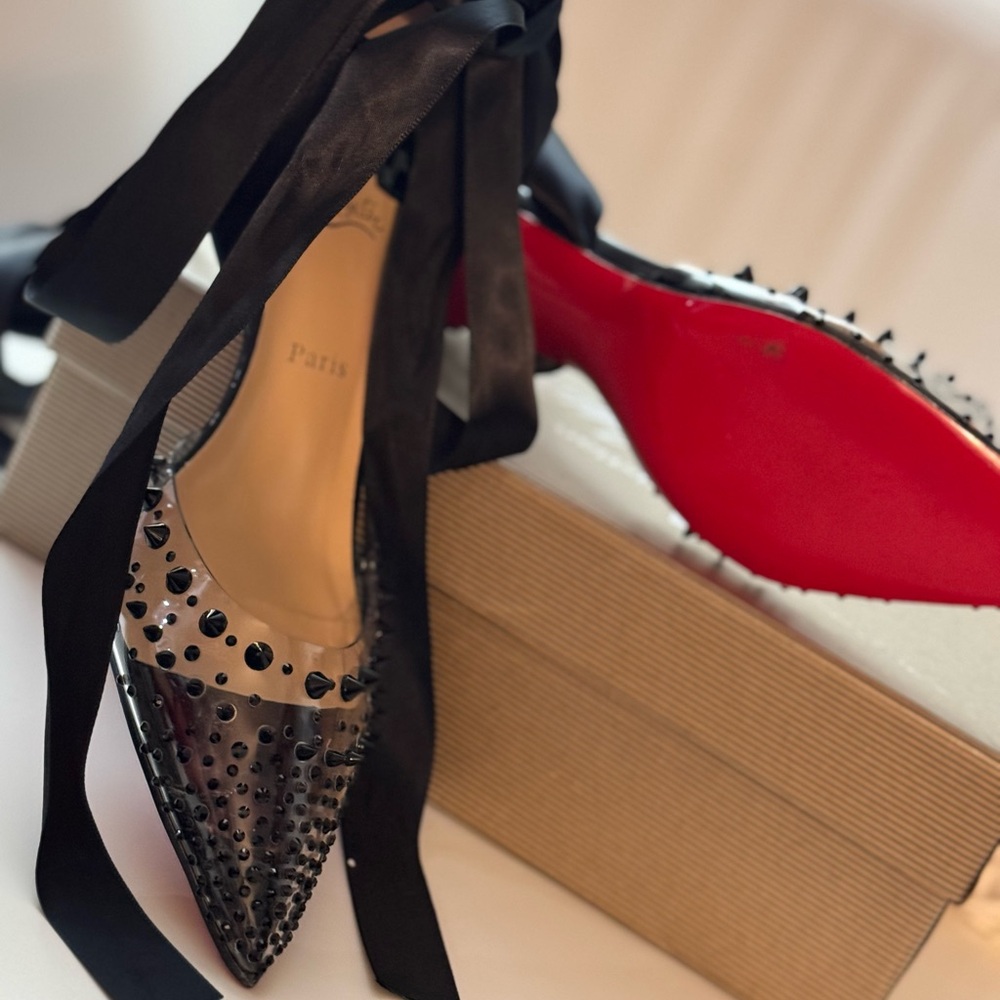 Stunning shoe with sexy spikes and ribbons tied. Comes with box and dust bag.